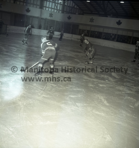 11224 (Tashiro) March 9/68 Sports Schmokey 500 Attend for Evening of Fun SATURDAY NIGHT’s SCHMOCKEY GAME, the first ever in Portage, had a little bit of everything for the 500 or more attending. After 2 periods, the game became more than what referees Red Gravelle and Wayne Richardson could handle. To start the third period, it was imperative that a stricter official be imported and believe it or not she was given a “red carpet” welcome by the combatants. REFEREES “RED” GRAVELLE AND WAYNE RICHARDSON were all business during Saturday night’s Schmockey game between the Liniment League All-Stars and the Minor Hockey Association executives. Here, Bill Brands of the P.M.H.A is being dragged to the penalty box for unnecessary speeding in the second period. 11224e.jpg