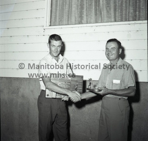 Moffat Aug.11/63 Sports
Left Hander Golf Tournament- Patterson Three Ladies Enter Open
Al Patterson, pro at the Winnipeg Breezy Bend club, goes through a familiar routine here Sunday, accepting the Mayfair trophy for winning the Canadian left-handed open golfing championship. This was the sixth time in eight attempts that Patterson has won the title. Patterson fired a new course 36-33----69 to finish 11 strokes ahead of the closest challenger. Tourney chairman Steve Swabuk, on the right, presented the Mayfair trophy to the winner.
Trail Blazers. Bernie Miller, Ruth Guichon, and Millie Kitson tote up the scores, left-handed of course, after their rounds in the Canadian left-handed open golfing championship here Sunday. Incidentally, they were the first women ever to compete in the event. Open is open, obviously, so the girls had no trouble having their entries accepted.
2051a.jpg