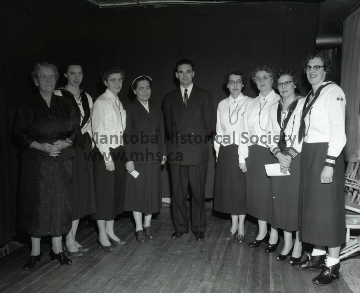 March 3rd, 1956, News, CGIT Group hears talk on immigrants, Miss Louis Mayova, centre, United Church worker at the port of entry of Montreal, was guest speaker at a dedication and affiliation service of Canadian Girls in Training and Explorers at the United Church secretary and active in the CGIT group. Rev. C.L. Barbour, right, was present at the ceremony 11000c.jpg
