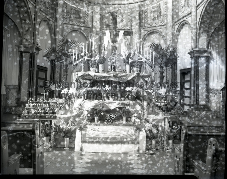 Easter altar decoration in church of assumption portray a work of art and planning. Vividly lighted with candles, this is the center of Ukrainian catholic religious services in Portage Le Prairie as they celebrate their Easter holiday by the old calendar. Easter services started Thursday and are carried through till Sunday when the Resurrection service will commence at 7am. April 15, 1955 10899.jpg
