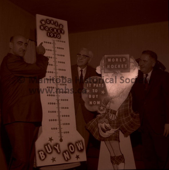 SELLING 1970 WORLD hockey tickets is a cinch, exudes public relations man Terry Hind. Why? Because we've got a fantastic product. Mr. Hind is seen pointing to the eventual target - 10,000 sets of tickets sold. Looking on is Winnipeg Enterprises Corporation manager Percy Downtown (right) and Harry Foxton, long-time Manitoba Amateur Hockey Association officer. 11302a.jpg