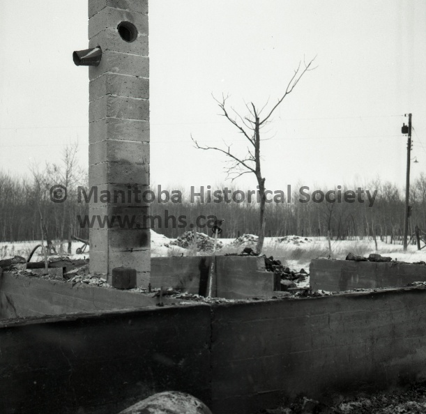 ONLY THE BASEMENT WALLS AND CHIMNEY remain standing of the Bagot district farm home destroyed by fire Tuesday night. The home was owned by Mr. and Mrs. R. Buckle who were in Fort William at the time of the fire.
A TOTAL LOSS- All contents of this farm home owned by Mr. and Mrs. R. Buckle of Bagot, were destroyed in a Tuesday night fire. Here a deep freeze, refrigerator, electric stove and other furnishings are shown in the remain of the basement where only the cement walls remain standing. 11490a.jpg