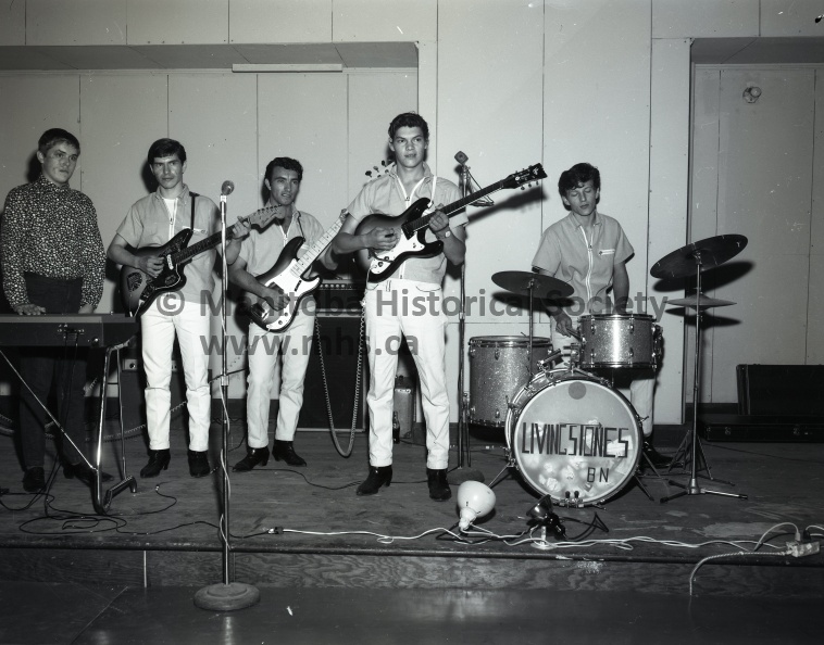 The Centre - Old Elite Theatre - The Livingstones
September 9th, 1966
The Livingstones - right to left: Billy Nodrick - drums, Johnny Dietrick - guitar, Raymond Klyne - bass guitar, Billy Asham - rhythm guitar. The above mentioned formed the group in 1965, since then, Rick Woyiwada, at extreme left, on the organ, has recently joined the band. Peter Swidnicki (not in photo) manages the band, and has kept the group together since its origin.
Portage's finest Rock 'n Roll band The Livingstones have put their time and efforts together, and have formed the New Centre as a means of providing Portage's young crowd with fine entertainment. Local and out-of-town talent will be provided every weekend. The dancehall has been remodled inside by the Livingstones, to give more dancing area. 9078a.jpg