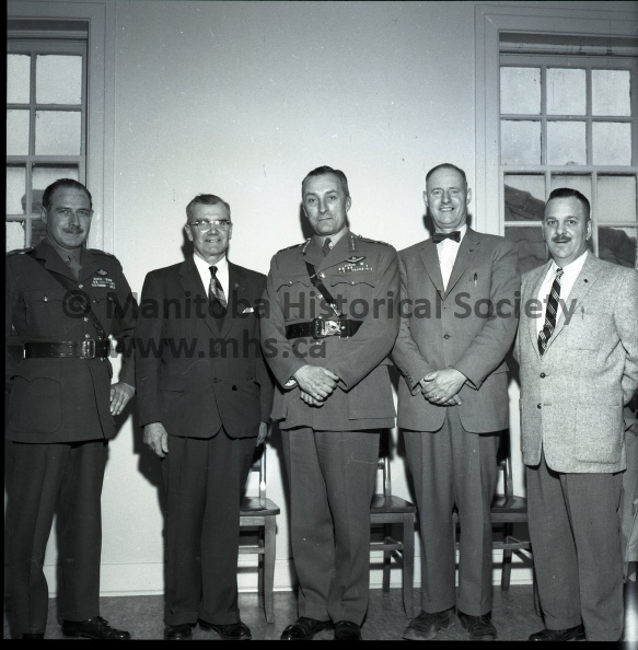 (Tashiro) April 27-1960 Civil Defence
Cd Headquarters In Portage Visited By Director Of National Survival
Director Of National Survival operations for the Canadian Army, Major-General Aurther E. Wrinch was a visitor to Civil Defence headquarters in Portage Wednesday. Seen here, left to right, are Major T. M. McDonald of the Generals staff; Mervin Dunham, civil defence officer for this area; Major-General Wrinch; Albert Bentley, deputy co-ordinator of Civil Defence; and Lt. Col. W. Burton of Portage. General Wrinch inspected facilities at the CD headequarters here. 10769a.jpg