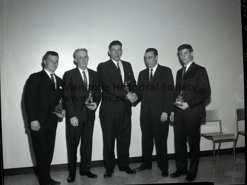 Tashiro May 11/67 Sports CURLING CLUB AWARDS PRESENTED
THE PORTAGE CURLING CLUB CHAMPIONS, Jim Moorhouse’s rink, being presented the Western Savings Shield by MCA president Fred Law at the windup banquet Thrusday at the ANAF hall. From the left are Don Ediger, Moorhouse, Law, Bill Paterson, and Gordon Tidsbury.
MONTE SIMPSON’S RINK, which received the International trophy for winning the B group championship of the Portage curling club. From the left are Larry Gibbs, Orval McDonald, Simpson, Hugh Mustard, representing the donor of the trophy, and Robert Simpson. The presentation was made Thursday at the Curling Club windup banquet.
THE GREENBURG RINK, which received the Tecza trophy for winning the D division championship of the Portage curling club. From the left are Allan Greenburg, Frank Tecza, the trophy donor, I. H. Greenburg, Bruce McDonald, and Jim Wilkinson. The winners received their awards Thursday at the club wind up banquet in the ANAF hall.
THE PORTAGE CURLING CLUB senior champions, the George Morris rink, receives the Acadian Distilleries trophy Thursday at the annual windup banquet in the ANAF hall. From the left are Gordon McKenzie, Len Hughes, Bruce Alexander, representing the sponsors, and George Morris. The other team member, Howard Roberts, is missing from picture.
THE MIXED CURLING CHAMPIOS who received the Linden trophy Thursday at the Portage curling club windup and banquet, Tom Marsh’s rink. From the left are Bud Spratt, Mrs. Spratt, Marge Tomalin, and Tom Marsh. Bill Linden, the donor, presented the trophy.
1765h.jpg