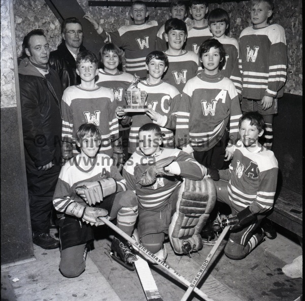 (Tashiro) March 8/71 Minor Hockey
Paperweight A
West End Beat Southside For City Championship
Portage Paperweight A Champions for 1970 - West End won the title with a 6-1 win in the third and deciding game with South Side. Front row left to right, David Bergeron, Shane Smith and Terry Bachalo. Second row left to right Murray Painter, Rodney Romyn, Darryle Henry. Third row coach Bill Henry, Adam Pankhurst, Tim Lockridge, Rick Whincup and Richard Kerwin. Back row, coach Lorne Henry, Ron Link, Kim Fingas and Dale Henry. Missing from the picture Stewart Jackson. 11199b.jpg