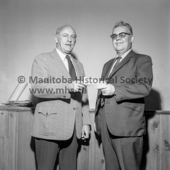 Photographer: Tashiro
December 7, 1971
United Way
Portage United Way Inc. receives a $100 cheque from Rotary
George Cassidy, treasurer of the Portage Rotary Club presents a cheque for $100 to the United Way from the Portage Rotary Club. Receiving the donation is campaign chairman Elly Brooker (right). VP-1-00766-001.jpg