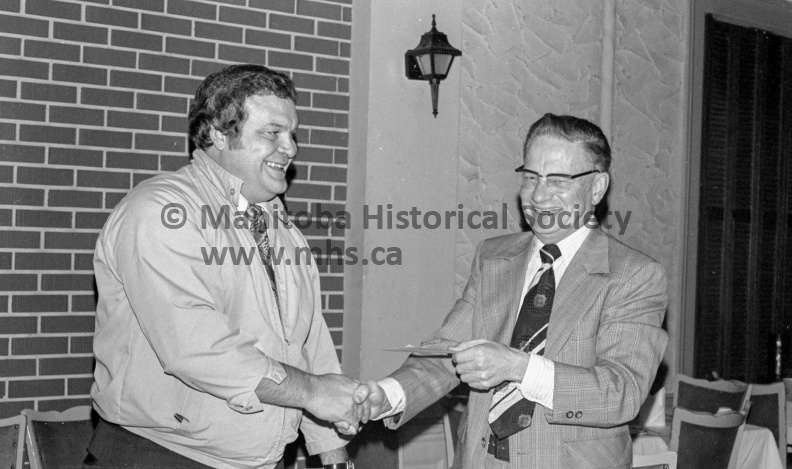 Photographer: Tashiro
1975-12-02
Rotary
Rotary gives $110 to United Way - UW total at $71,800
Reason to be happy
Dr. C. M. Thomas’ expression in the photo above is of the happiest man in Portage. He’s accepting on behalf of United Way a cheque from Gord Pankhurst, president of the Rotary Club. But the big smile comes from the knowledge that as of Tuesday noon, the United Way campaign stood at $71,800, comfortably over the 1975 quota. VP-2-01493-002.jpg