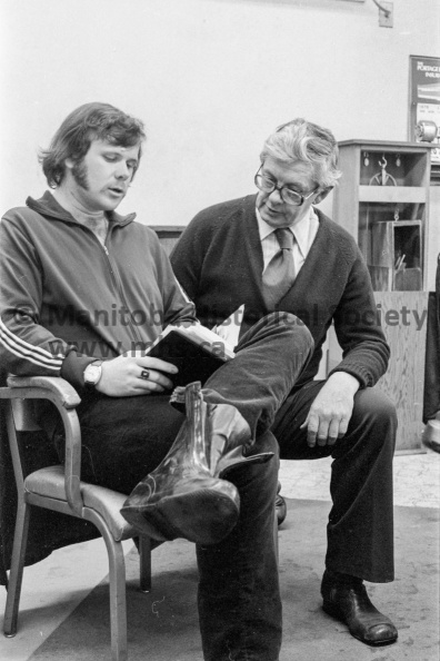 Photographer: Tashiro
January 20, 1975
Arc Industries
Walking across Canada for mentally retarded - Impressed with ARC Industries
Frozen feet
Ken Weldrick, the ‘Happy Jogger’ is paying an unscheduled visit in Portage la Prairie. En route from Vancouver to the East via ‘shankmare’ he was forced to stop over in Portage la Prairie when he froze his feet severely during that big blizzard last weekend. He was advised to stay in Brandon, but bent on reaching the east and raising pledges for the mentally retarded, he was and is determined to ‘keep going.’ He is seen here with B. G. (Buzz) Bratton, manager of ARC Industries in Portage la Prairie, who later showed him around the ARC workshop. VP-2-00002-004.jpg