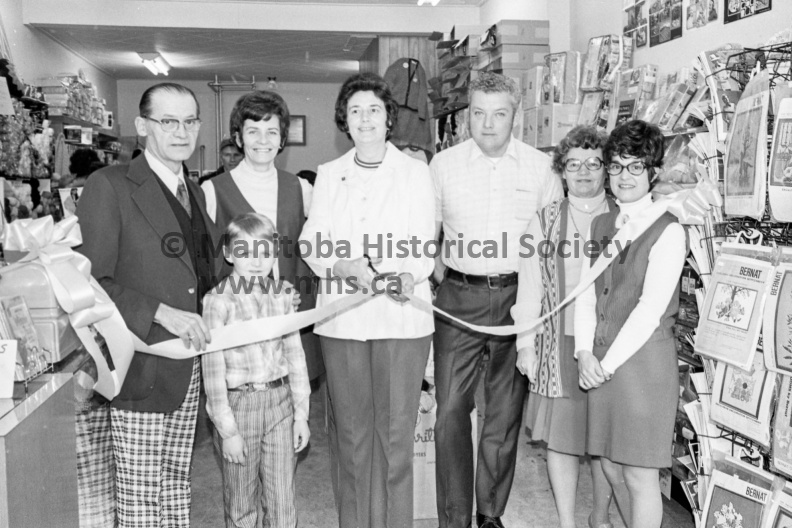 Photographer: Tashiro
February 1, 1975
Busy Fingers Knit Shop
Busy Fingers Knit Shop official opening
A new knit shop
A new store, the Busy Fingers Knit Shop operated by Mr. and Mrs. Roy Smith was officially opened over the weekend when Portage Mayor Karen Devine cut the ceremonial ribbon. Also attending the Saturday opening was 10-year-old Barry Wright, son of Mr. and Mrs. Lorne Wright of rural Portage who named the new shop. The official party in the photo are, from the left, AId. A. R. Barrett, Mrs. Smith, Mayor Devine, Mr. Smith, Mrs. Lillian Maxwell and Mrs. Sylvia Roberts. Young Barry is at the front. VP-2-00015-001.jpg