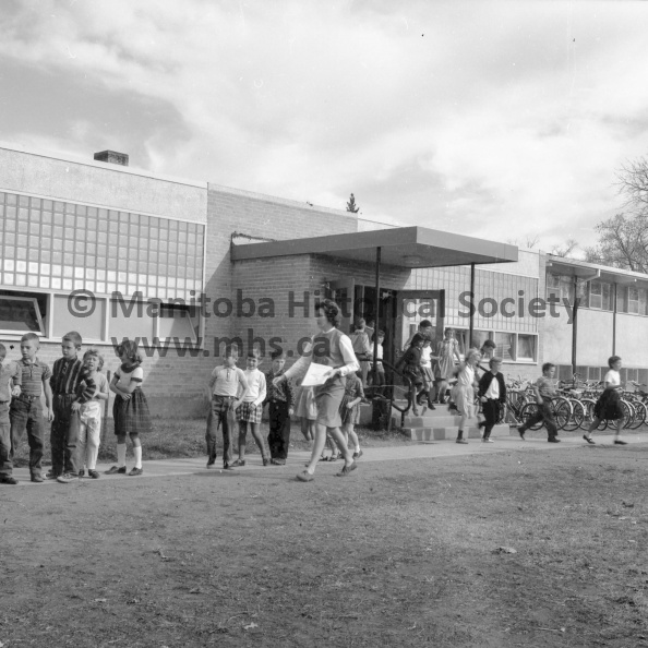 Photographer: Tashiro
October 10, 1963
Educational
City schools observe fire prevention week
Public school students at Fort la Reine School are seen lined up outside the school which was evacuated at the sound of the fire alarm triggered by Portage la Prairie fire chief George Spriggs. The test by the fire chief was held Thursday in conjunction with the National Fire Prevention campaign now in progress. VP-1-00104-002.jpg