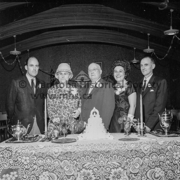 Photographer: Tashiro
August 21, 1963
Anniversary
Mr. and Mrs. Dan Kennedy anniversary
Together again. The Golden Wedding anniversary of Mr. and Mrs. Dan Kennedy, above, was even more joyous because all three of their children were home together for the first time in 22 years. Pictured above with Mr. and Mrs. Kennedy are sons, Len of Toronto, left, and Frank of Cochenour, Ont., and daughter Kathleen, Mrs. Jack McCarron, Waterloo, Ont. VP-1-00901-003.jpg