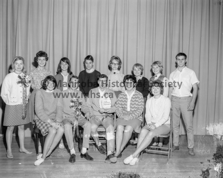Photographer: Tashiro
October 1, 1965
Education
PCI Lit. Soc. executives
New officers of the PCI Literary Society are shown here following their election Friday. They are, left to right, seated, Linda Parrott, editor; Mervin Dahl, vice-president; Tom Burton, president; Elizabeth Sherritt, secretary; Jo-Dee Carmichael, treasurer; standing, Dorothy Vopni, sub-editor; Marjorie Dutson, assistant editor; Linda Pappas, business manager; Brian Muirhead, reporter; George Busby, pianist; Anne Coghill, social editor; Lynda Johnston, girls sports editor; Gordon Cuff, boys sports editor. VP-1-00609-001.jpg