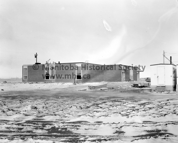 Photographer: Tashiro
December 18, 1961
Civic Affairs
North end school construction on schedule
Working towards an opening date early in the new year, contractors have been making excellent headway on the new North Ward school, shown above, and now completely closed in. This is a view from the south, showing the front entrance at the east and the south side of the new building. VP-1-00173-001.jpg