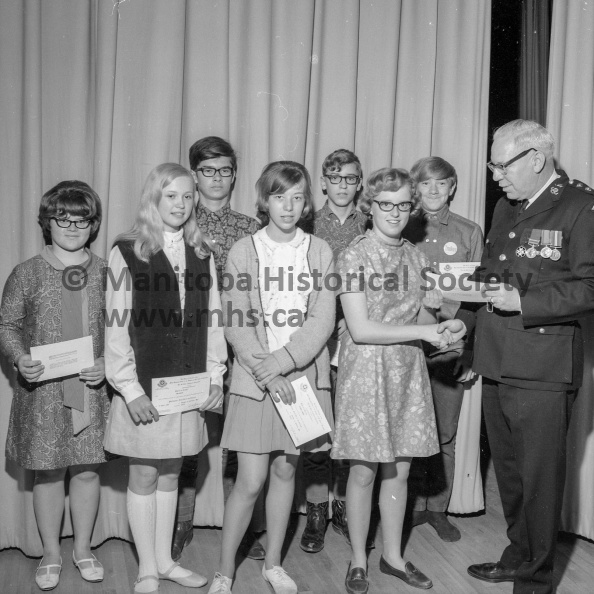 Photographer: Tashiro
June 18, 1968
Education
Prince Charles students receive first aid certificates
Regular health classes in grade 8 at Prince Charles school this year included first aid and a St. John Ambulance examination. Some 175 students have received their certificates. At right is Ifor Jones, divisional superintendent for St. John making the presentation to one group which included, l to r, front, Lorna Sissons, Brenda Prawdzik, Barbara Anne Robinson; back row, Judy McNaughton, Darryl Young, Guy Grimsen, Alan Hardy. VP-1-00231-001.jpg