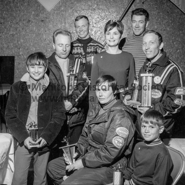 Photographer: Tashiro
March 6, 7, 8, 1970
Fun Festival
Sally Cuthbert ’70 Queen - Night Parade - Activities and event winners
Portage Blizzard racing team over the weekend captured a fair share of the prizes in M.S.R.A sanctioned races on Crescent Lake as part of the Centennial Year Winter Fun Festival. With the team is Portage Queen Sally Cuthbert. Members are, going clockwise from upper left, Bob Demman, Bryce McRorie, Jack Ediger, Randy McRorie, Judy Cochrane, Glen Fempel and Canadian champion Larry Mauws. VP-1-00484-051.jpg