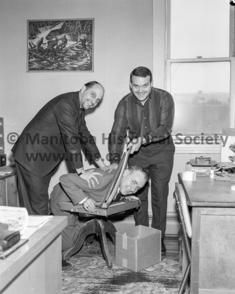Photographer: Tashiro
January 18, 1966
Carnival
Winter Fun Festival - Beard growing
The French Revolution all over again? Nope, just a couple of Winter Fun Festival beard growers happily taking vengeance on Harold Narvey who is not among the beard fanciers. Official guillotiner is Gord Pankhurst and his willing helper is Jack Follett, two of among some 50 Portagers now showing signs of new chin foliage being grown for festival time. Anyone else want to grow a beard and enter? Just contact any of the trio above, provided the knife hasn't fallen all the way by that time and Harold is no more. VP-1-00518-001.jpg
