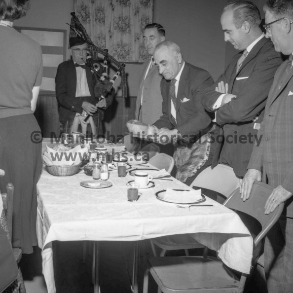 Photographer: Tashiro
January 25, 1963
Social
Portage Scots honor Robbie Burns - Haggis piped in
Portagers of Scottish descent gathered Friday to honor the birthday of the famous Scottish bard, Robbie Burns. Here Mr. Sutherland pipes in the haggis at the traditional dinner, while H. Gillespie, center, looks on, as Bill Murray presents the Haggis. VP-1-01021-001.jpg