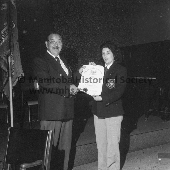 Photographer: Armstrong
June 23, 1974
A.N.A.F.
Webster Burton receives national recognition
National recognition
Webster Burton of Portage la Prairie, Sunday received the ANAF's national award Order for Service during a unit general meeting. Mrs. Dorothy Blake represented Dominion Command president Frank H. Farley in making the presentation, first such award to be made to a Portager. VP-1-01059-001.jpg
