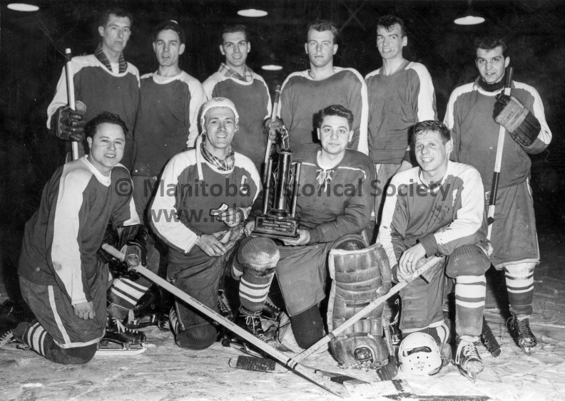 RCAF
March 19, 1964
Southport
Southport Intersection hockey champions + trophy
Team captain Joe Daigle proudly displays his 63-64 Hockey Chevron, while goalie Jag Young clutches the Southport Intersection Hockey Trophy. The Repair squad won the rubber game of a two-out-of-three final series to capture the league trophy. Others in the picture are, front row (left to right), LAC's Ellis, St. Pierre, White, Anderson, Comtois and Gushuliak. Front row: LAC's Belanger and Ladouceur. VP-1-01157-001.jpg