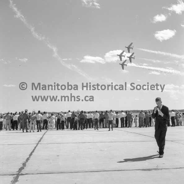 Photographer: Tashiro
July 12, 1963
RCAF Southport
Southport Air Force Day observance
Familiar diamond formation of the Golden Hawks of the Royal Canadian Air Force as it swept across the field at RCAF station Southport Friday. The Hawks staged their usual thrilling and exciting aerobatics for a turnout of some 3,000 people who took advantage of the open house to watch the show and to view several static displays. VP-1-01164-007.jpg