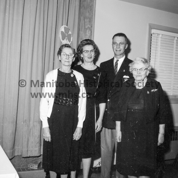 Photographer: Moffat
March 25, 1964
Legion
Legion Auxiliary - 25 years service pins - Cheque presentations
25 year service pins in the Ladies Auxiliary to the Royal Canadian Legion in Portage were presented Wednesday to Mrs. D. Setter, extreme left, and Mrs. F. Hinds, extreme right. Making the presentations were Auxiliary president Mrs. Jean Gibson and branch president Ken Holland. VP-1-01251-003.jpg