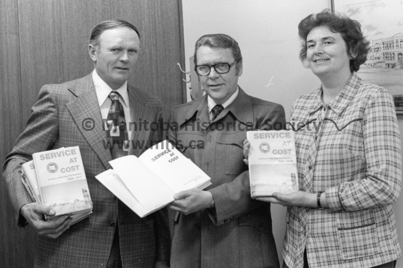 Photographer: Tashiro
April 9, 1976
Man. Pool Elevators
Manitoba Pool Elevators history book is off the press for distribution
Man. Pool history
Manitoba Pool Elevators' Service at Cost depicting the farmer-owned grain handling company's 50 years of operation has been completed. Over the weekend, several volumes of the publication were presented to city junior highs and high schools as well as to the public library. Pool director Frank Sissons, left, made the presentations. Receiving on behalf of the schools is superintendent Virgil Holmes, centre. Mayor Karen Devine, right, accepted a volume on behalf of the library. VP-2-00106-002.jpg